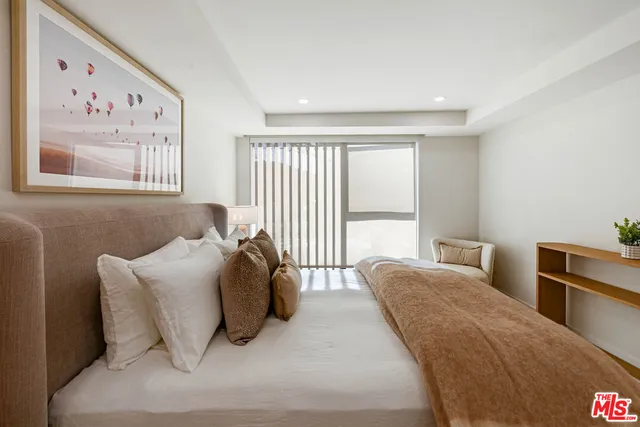 a bedroom with a bed and glass window