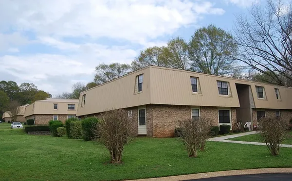 a view of house with backyard