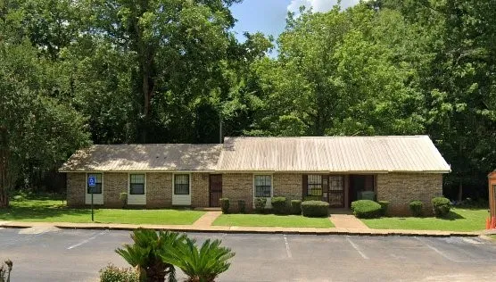 a view of house with a yard and fence
