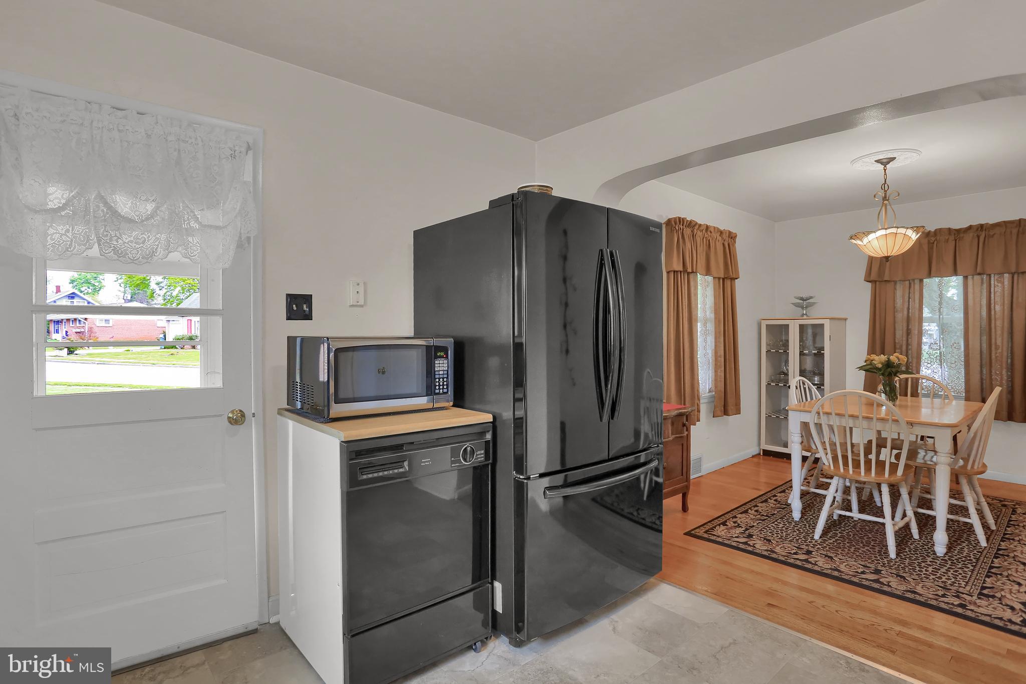 741 Gunnison Road York, PA 17404 - Photo 15 of 35 a kitchen with granite countertop a refrigerator and a dining table
