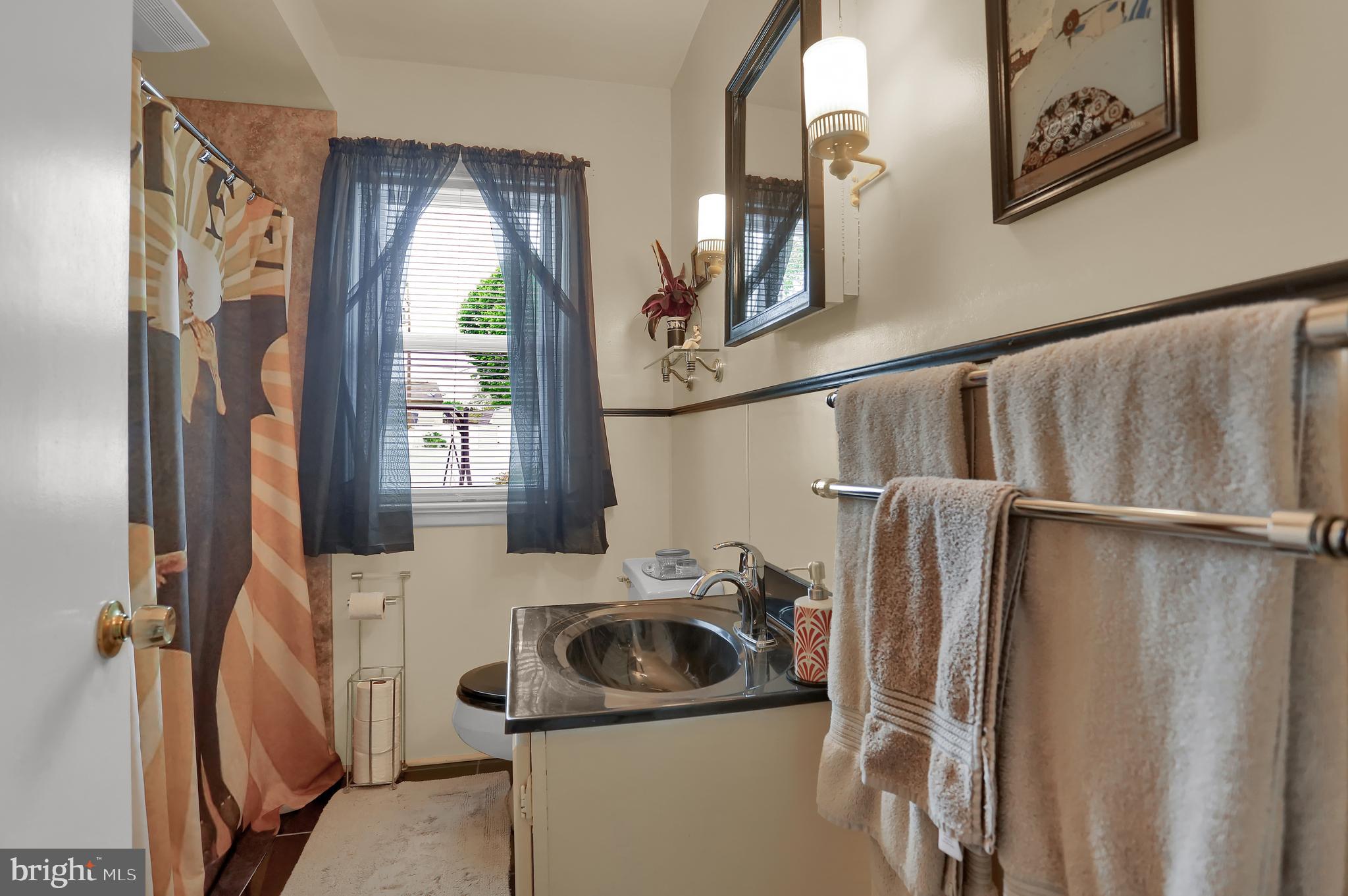 741 Gunnison Road York, PA 17404 - Photo 16 of 35 a bathroom with a sink a mirror and shower