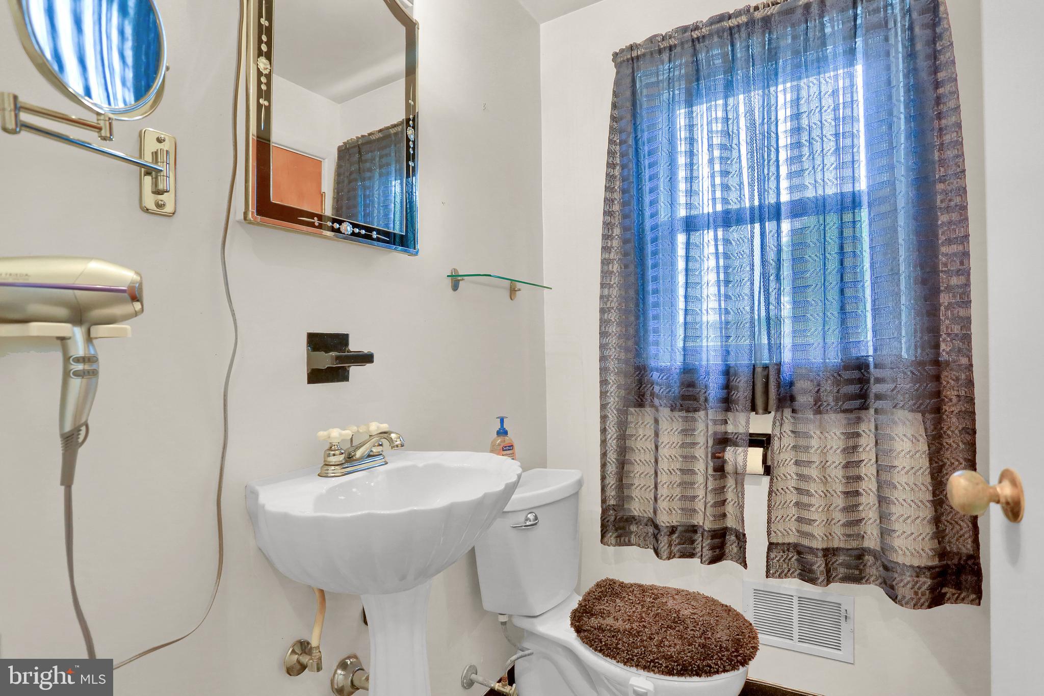 741 Gunnison Road York, PA 17404 - Photo 23 of 35 a bathroom with a toilet a sink and mirror