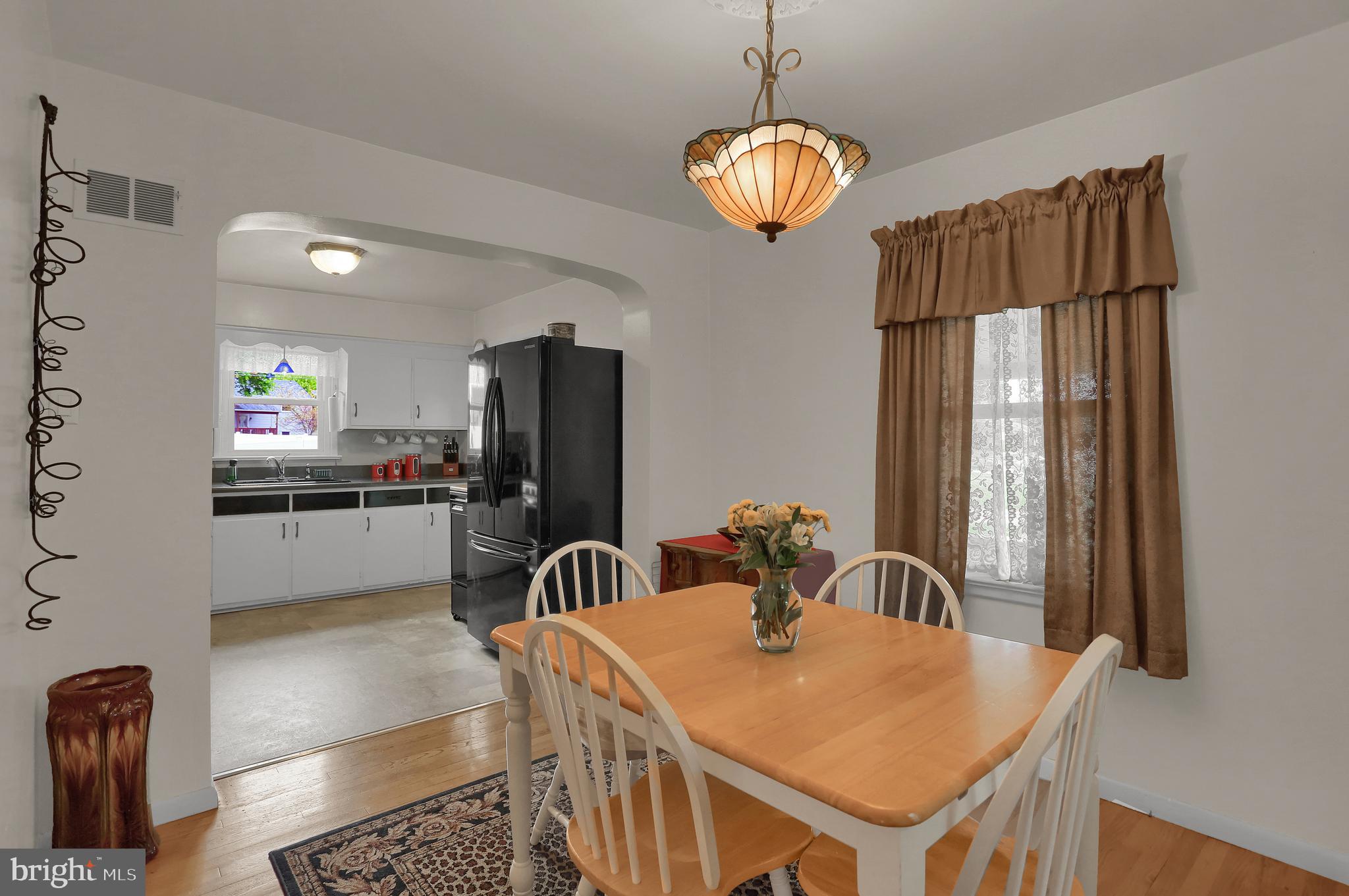 741 Gunnison Road York, PA 17404 - Photo 8 of 35 a room with stainless steel appliances kitchen island granite countertop a table chairs in it and wooden floors