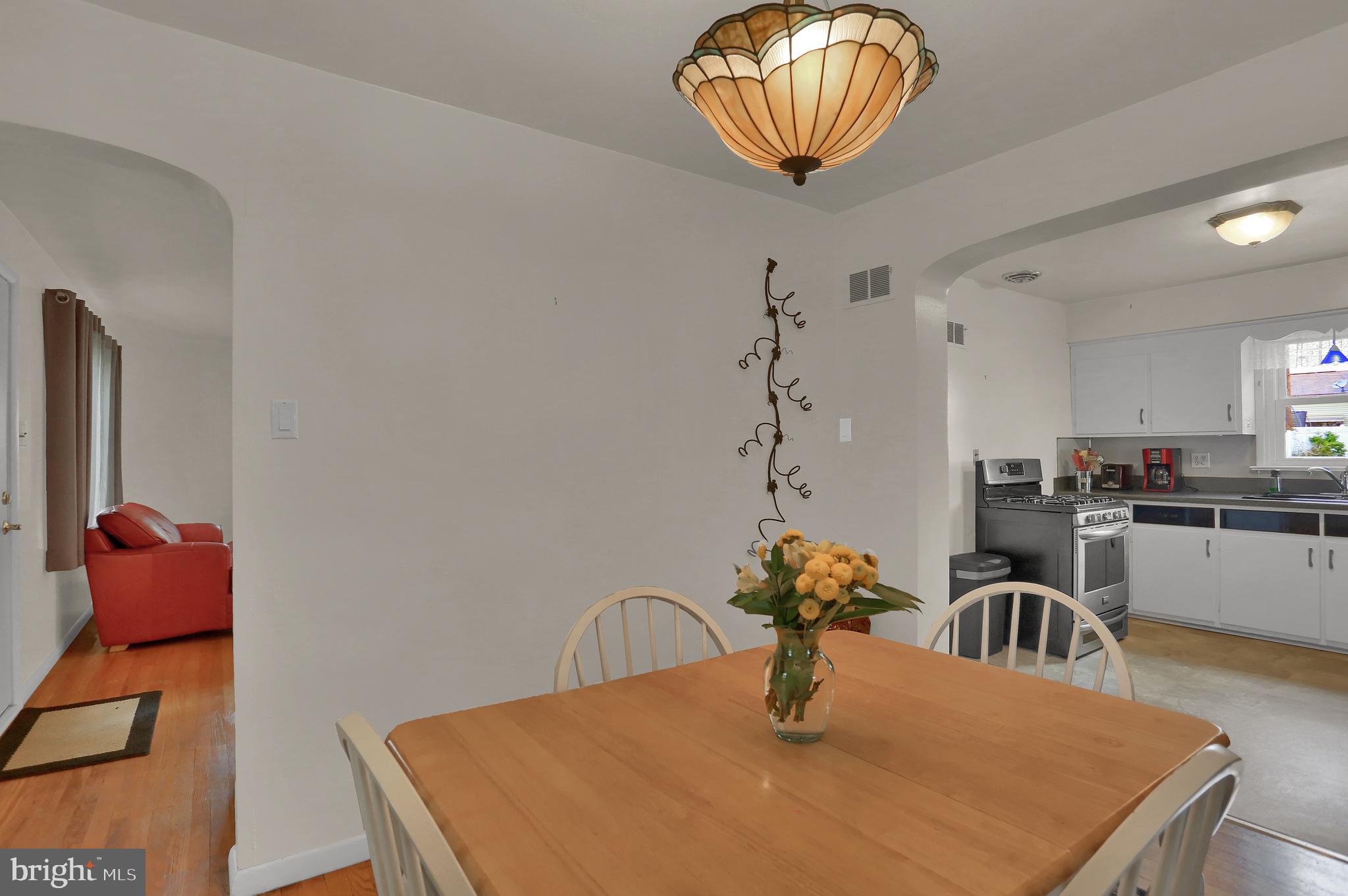741 Gunnison Road York, PA 17404 - Photo 9 of 35 a kitchen with a table chairs and a refrigerator