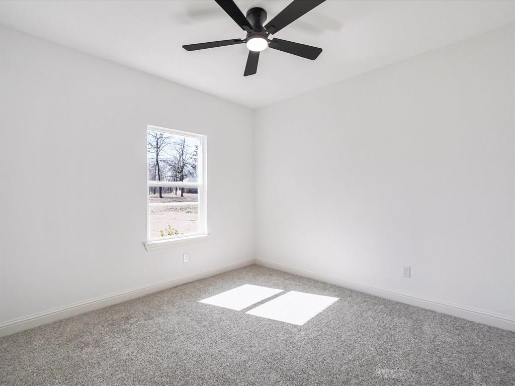 448 Rs County Road Alba, TX 75410 - Photo 8 of 34 an empty room with a window and a fan
