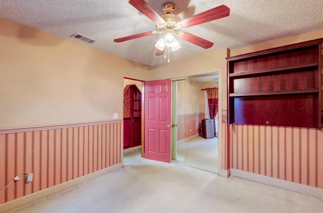 a patio with a table and chairs under an umbrella