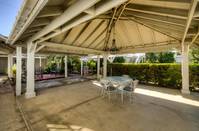 a view of a porch with furniture and a yard