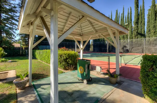 a view of a patio with a table and chairs and potted plants
