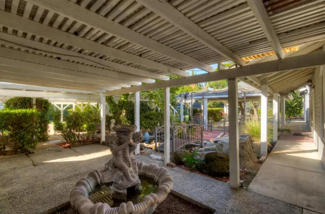 a view of a house with a yard patio and fire pit