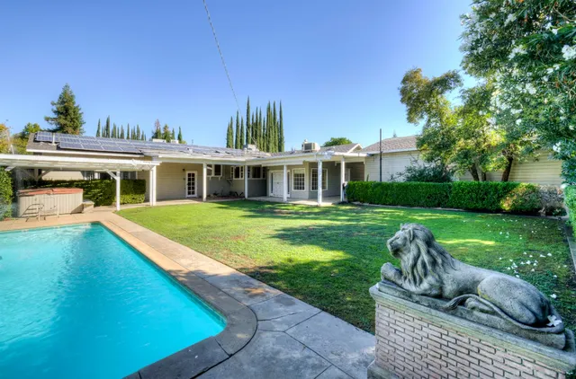 an aerial view of residential house with outdoor space and swimming pool