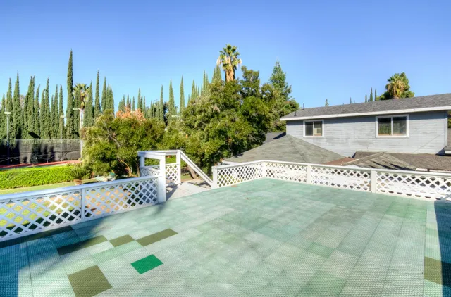 an aerial view of residential houses with yard