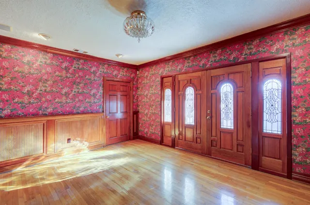 a view of a livingroom with wooden floor and cabinet