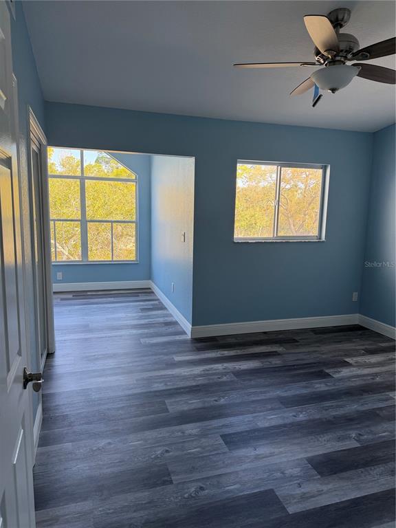 9794 Indian Key Trail, Unit 91 Seminole, FL 33776 - Photo 14 of 20 a view of an empty room with a window and wooden floor