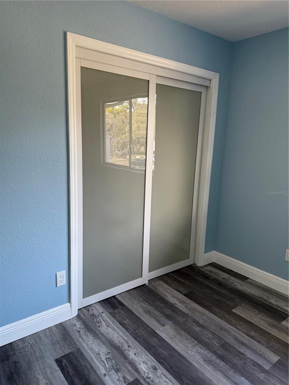 9794 Indian Key Trail, Unit 91 Seminole, FL 33776 - Photo 17 of 20 a view of an empty room and wooden floor