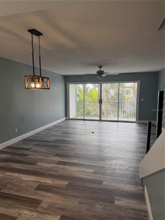 9794 Indian Key Trail, Unit 91 Seminole, FL 33776 - Photo 5 of 20 a view of empty room with wooden floor and fan