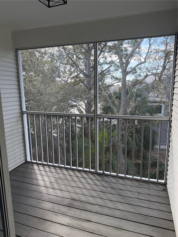 9794 Indian Key Trail, Unit 91 Seminole, FL 33776 - Photo 8 of 20 a view of a balcony with wooden floor