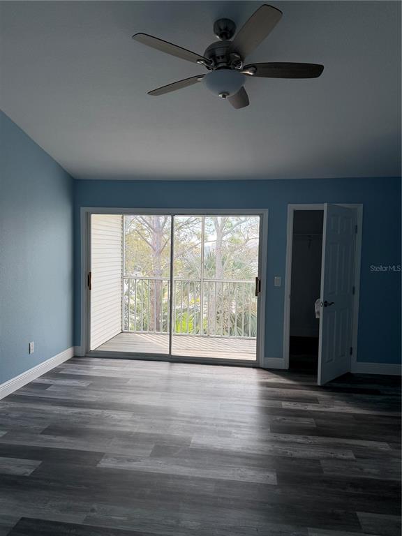 9794 Indian Key Trail, Unit 91 Seminole, FL 33776 - Photo 9 of 20 a view of an empty room with wooden floor and a window