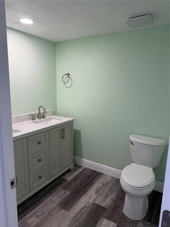 9794 Indian Key Trail, Unit 91 Seminole, FL 33776 - Photo 10 of 20 a bathroom with a toilet sink and mirror