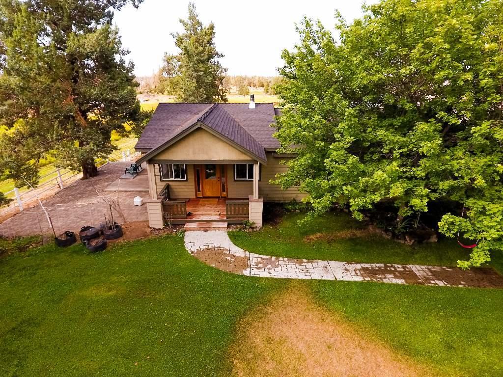 22810 Nelson Road Bend, OR 97701 - Photo 3 of 43 a front view of a house with a yard table and chairs