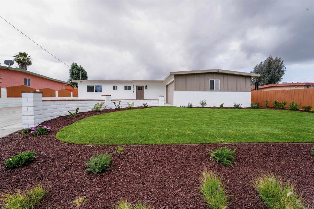 1314 Bluegrass Road Vista, CA 92083 - Photo 16 of 16 a view of a house with a yard and a garage