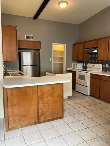 a kitchen with stainless steel appliances granite countertop a stove sink and cabinets