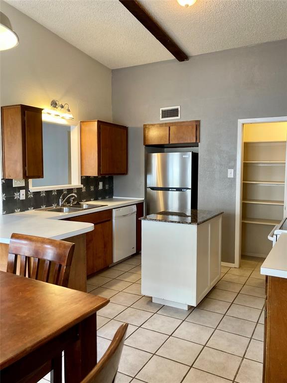 2714 McCart Avenue, Unit 2712 Fort Worth, TX 76110 - Photo 18 of 39 a kitchen with stainless steel appliances granite countertop a stove a sink a microwave and a refrigerator