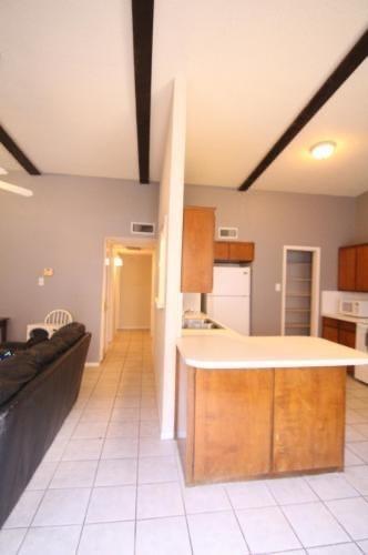 2714 McCart Avenue, Unit 2712 Fort Worth, TX 76110 - Photo 20 of 39 a kitchen with a sink and a refrigerator