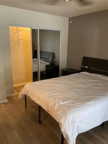 a bed sitting in a bedroom and a table