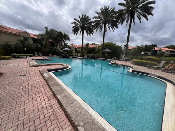 a view of swimming pool with a table and chairs