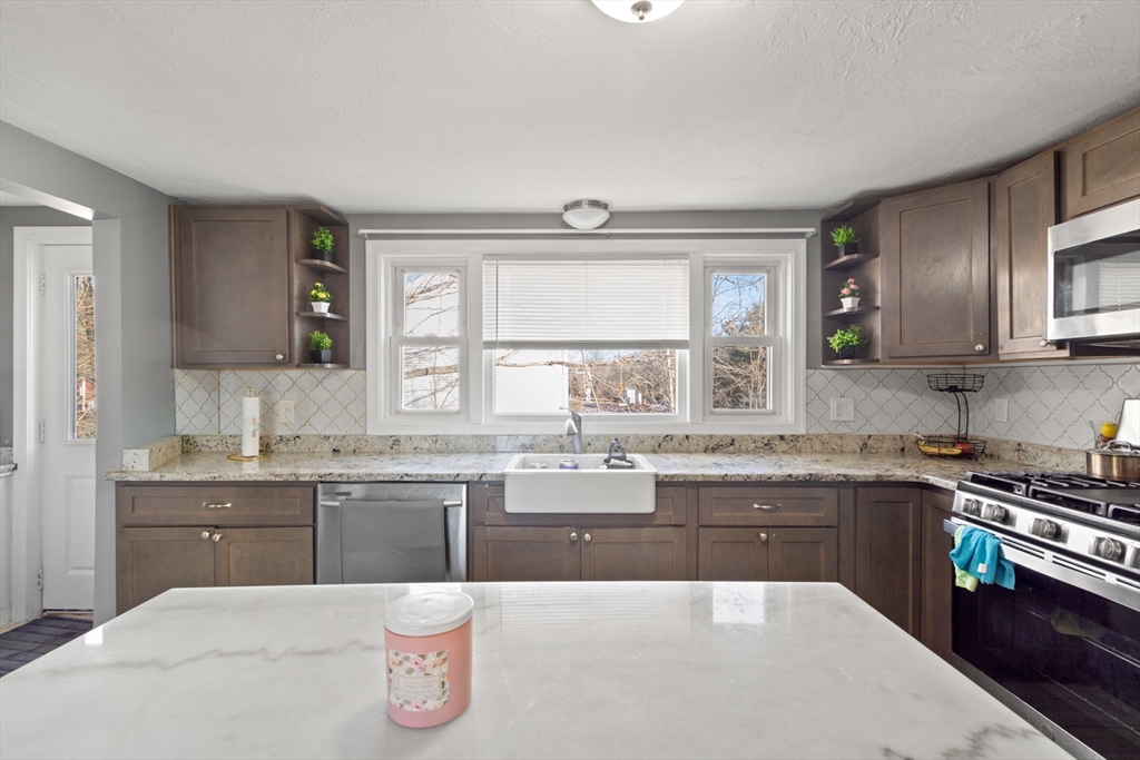 48 Wall Street Bridgewater, MA 02324 - Photo 13 of 29 a kitchen with a sink stove and cabinets