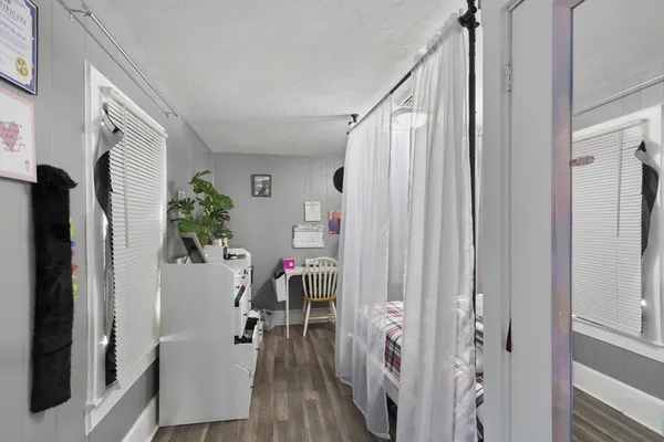 a bathroom with a shower curtain and mirror