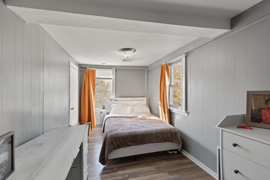 48 Wall Street Bridgewater, MA 02324 - Photo 18 of 29 a bedroom with a bed and a flat tv screen on dresser