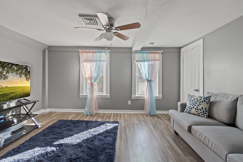 48 Wall Street Bridgewater, MA 02324 - Photo 19 of 29 a living room with furniture and a flat screen tv