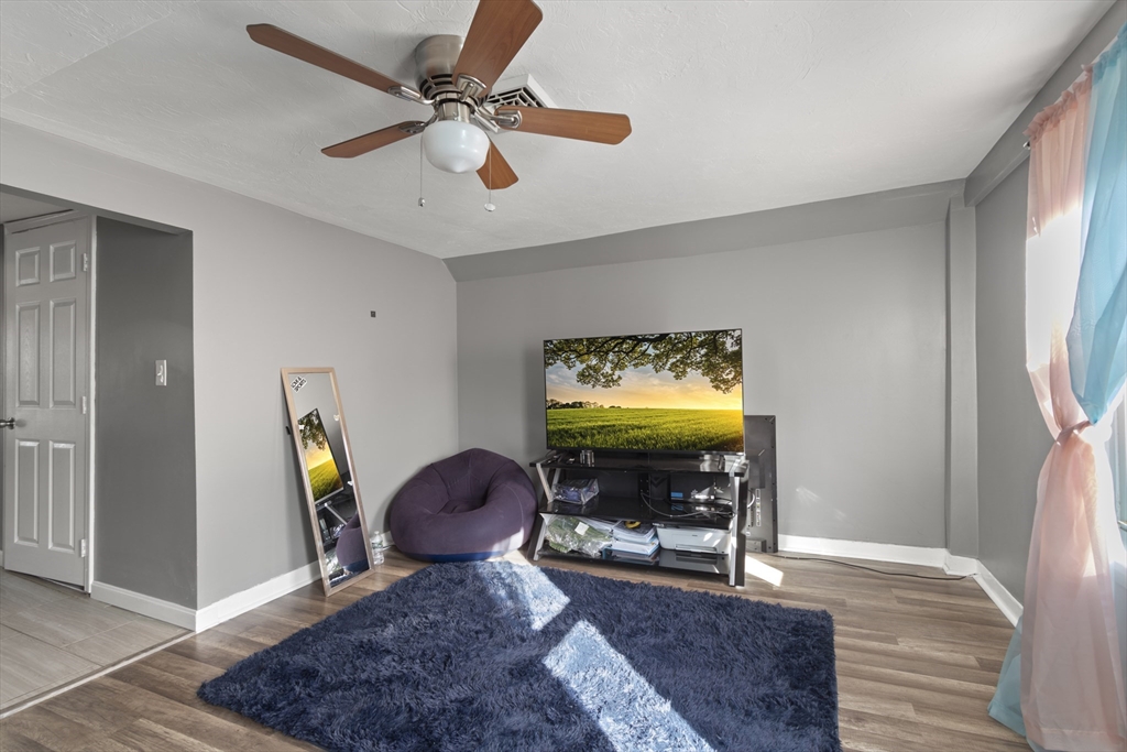 48 Wall Street Bridgewater, MA 02324 - Photo 20 of 29 a view of a livingroom with furniture and a ceiling fan