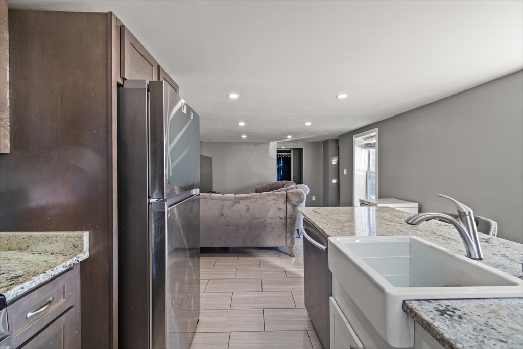 48 Wall Street Bridgewater, MA 02324 - Photo 6 of 29 a kitchen with stainless steel appliances granite countertop a sink a refrigerator and a granite counter tops