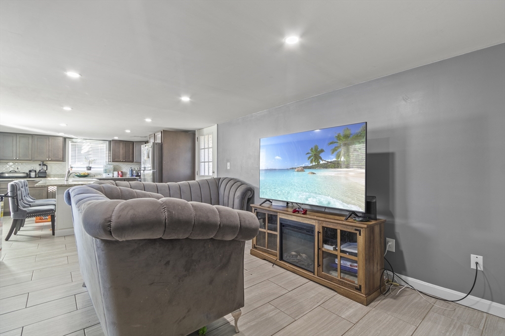 48 Wall Street Bridgewater, MA 02324 - Photo 7 of 29 a living room with stainless steel appliances furniture and a flat screen tv