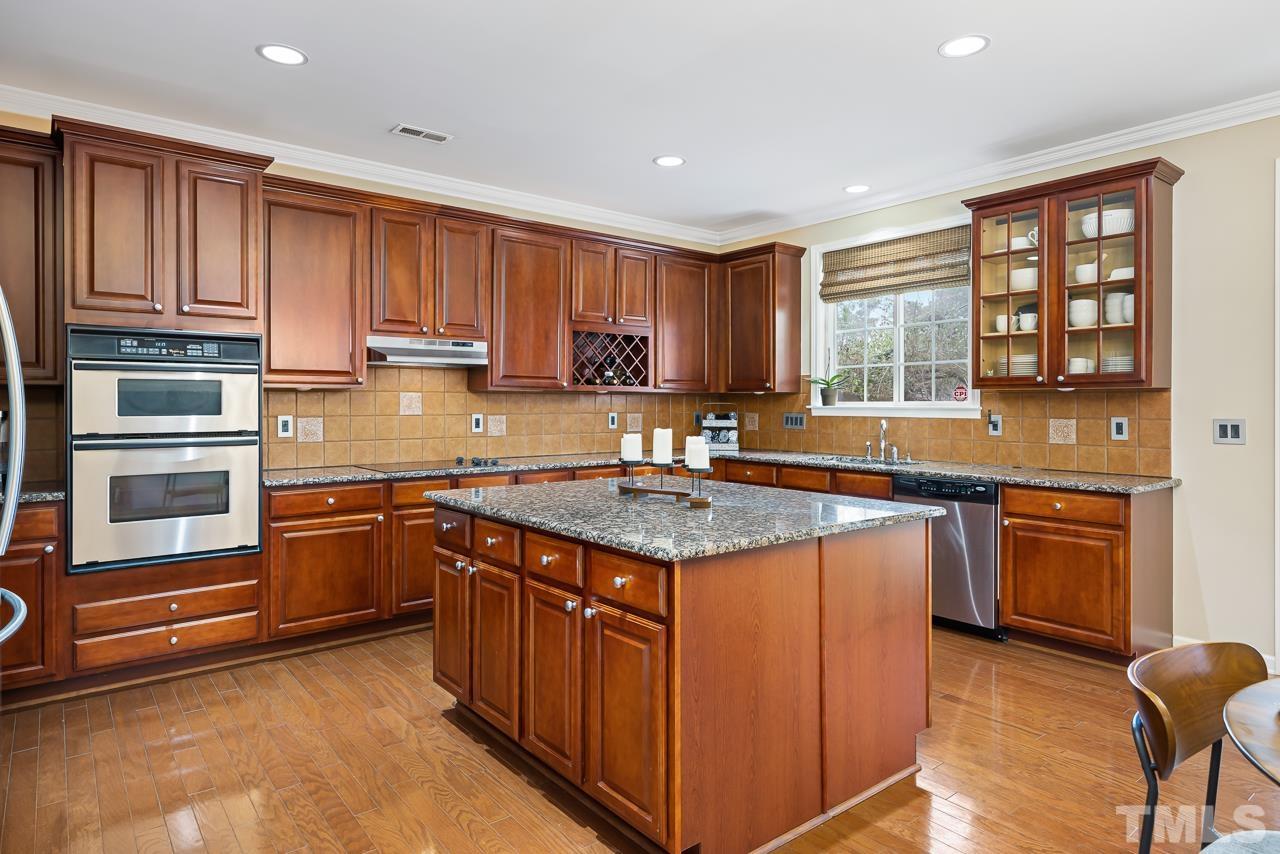 2836 Roundleaf Court Raleigh, NC 27604 - Photo 11 of 39 a kitchen with stainless steel appliances granite countertop a stove a sink and a refrigerator