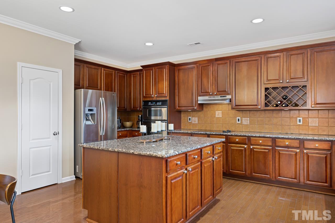 2836 Roundleaf Court Raleigh, NC 27604 - Photo 12 of 39 a kitchen with stainless steel appliances granite countertop a sink stove and refrigerator