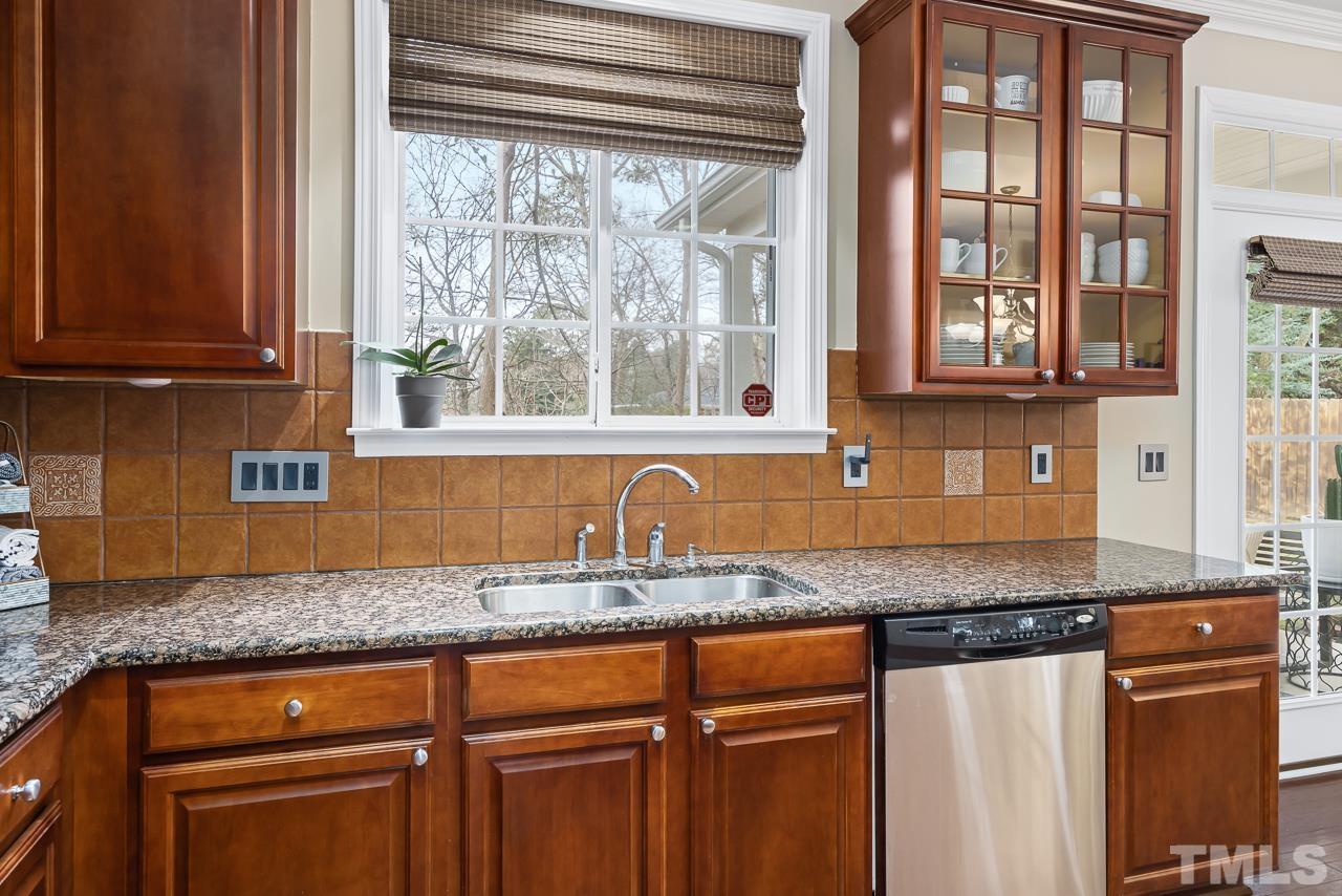 2836 Roundleaf Court Raleigh, NC 27604 - Photo 14 of 39 a kitchen with granite countertop a sink and a window