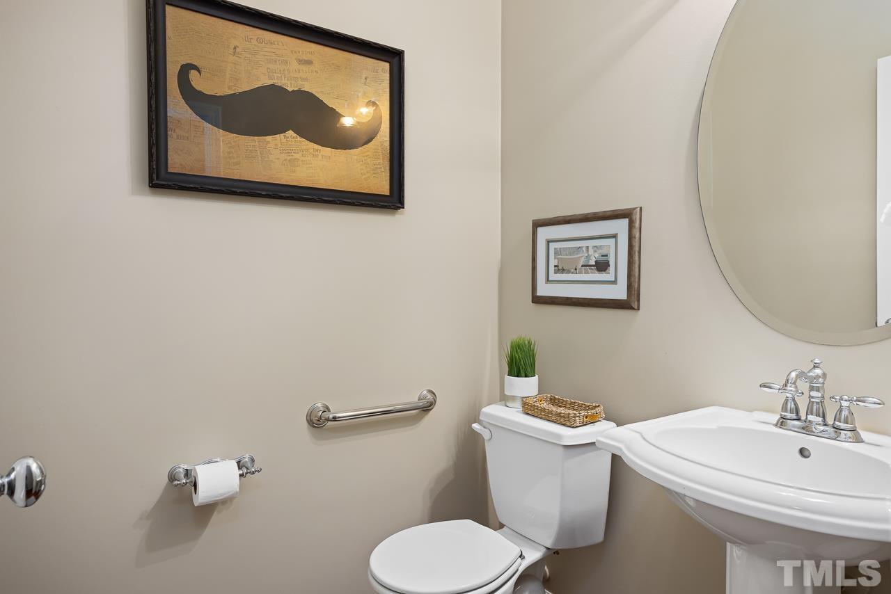 2836 Roundleaf Court Raleigh, NC 27604 - Photo 15 of 39 a bathroom with a toilet sink and mirror