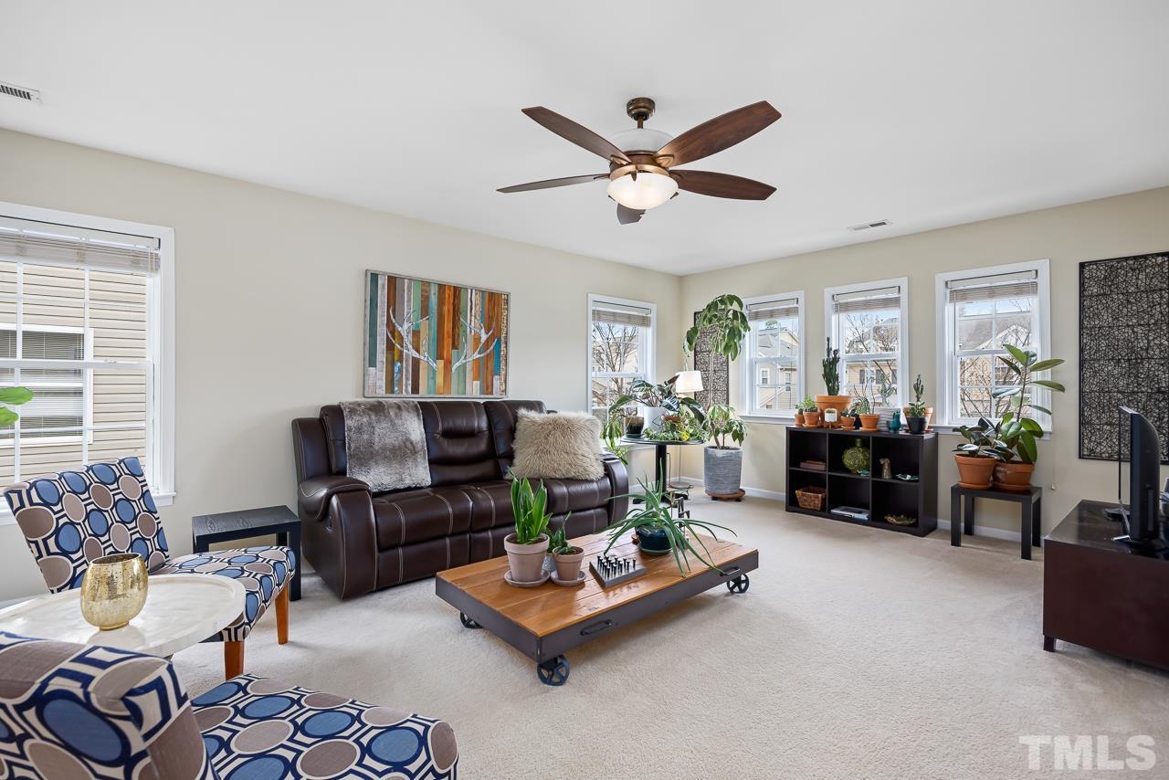 2836 Roundleaf Court Raleigh, NC 27604 - Photo 18 of 39 a living room with furniture gym equipment and a window