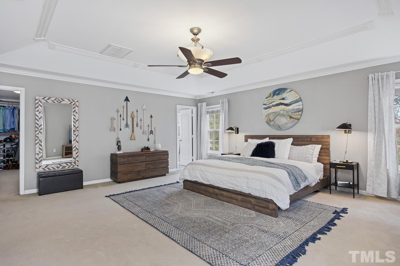 2836 Roundleaf Court Raleigh, NC 27604 - Photo 21 of 39 a spacious bedroom with a bed and ceiling fan