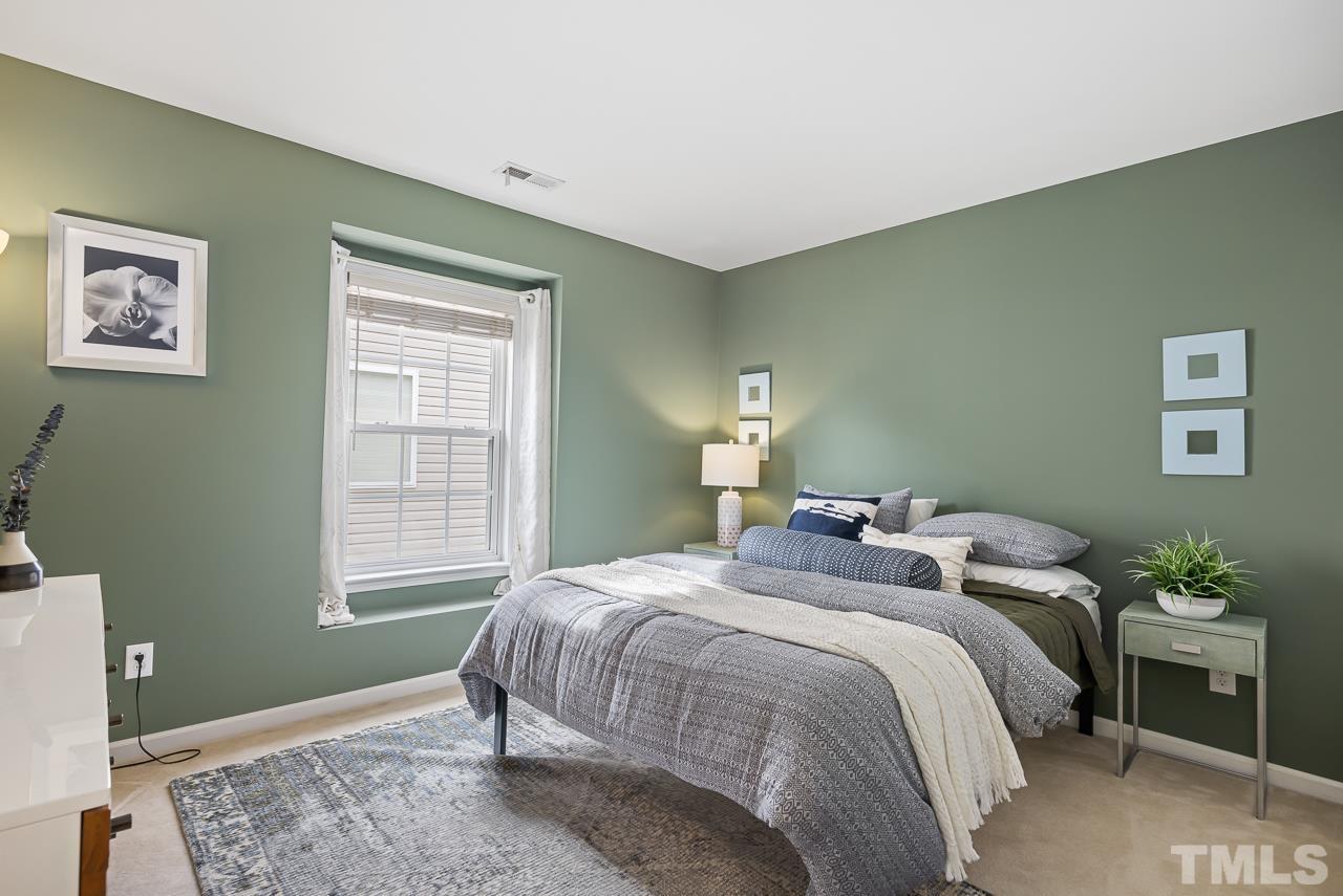 2836 Roundleaf Court Raleigh, NC 27604 - Photo 27 of 39 a bedroom with a bed and a window