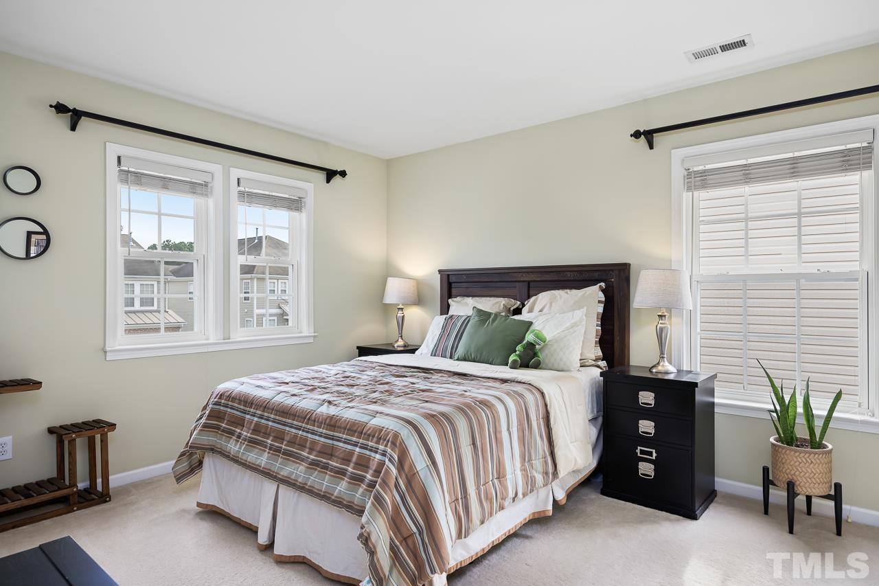 2836 Roundleaf Court Raleigh, NC 27604 - Photo 28 of 39 a bedroom with a bed and windows