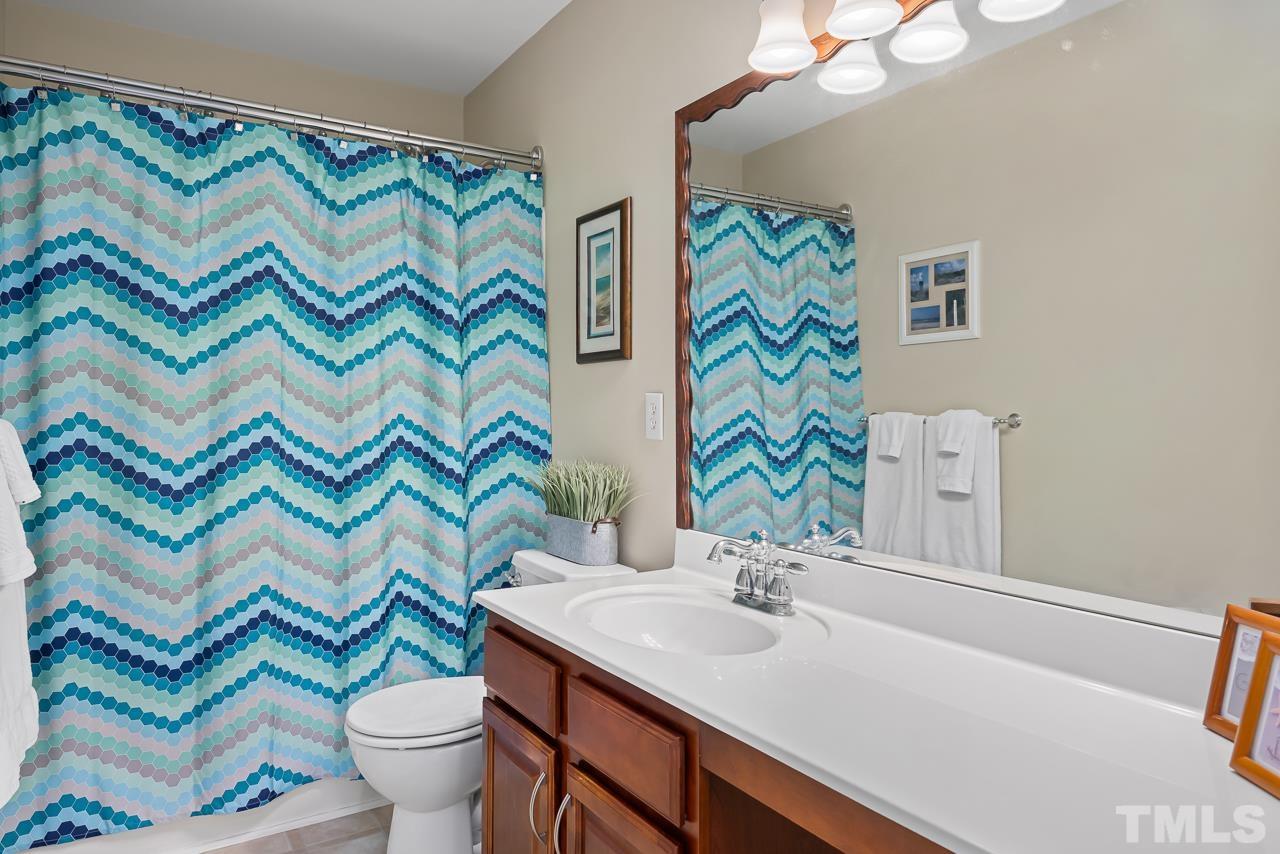 2836 Roundleaf Court Raleigh, NC 27604 - Photo 29 of 39 a bathroom with a sink a toilet and a mirror