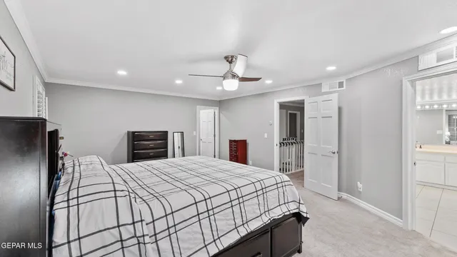 a bedroom with a bed and a ceiling fan