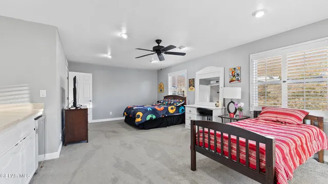 a view of a big house with a big yard and large trees