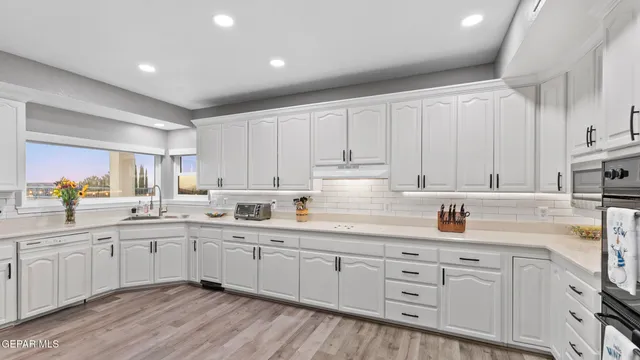 a spacious bedroom with a bed and a chandelier