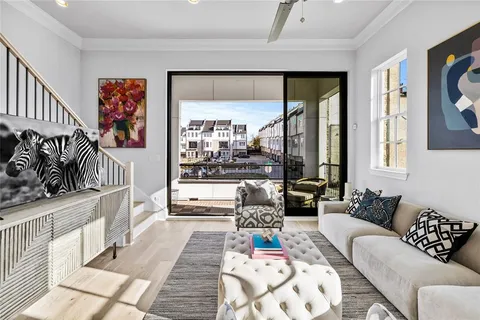 a living room with furniture and a floor to ceiling window
