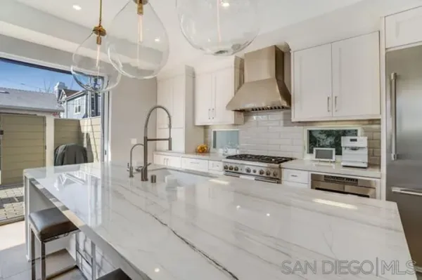 a kitchen with stainless steel appliances granite countertop a sink and a stove